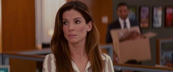 Movie still from “The Proposal” (2009), directed by Anne Fletcher – A woman with long brown hair looking to her left; Close Up shot, Over the shoulder angle