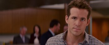 Movie still from “The Proposal” (2009), directed by Anne Fletcher – A person wearing a plaid shirt; Close Up shot, Over the shoulder angle
