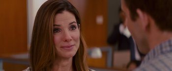 Movie still from “The Proposal” (2009), directed by Anne Fletcher – A person with long brown hair; Close Up shot, Over the shoulder angle