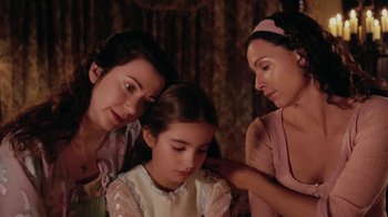 Movie still from “Ella Enchanted” (2004), directed by Tommy O'Haver – A woman and two women sitting next to each other; Close Up shot, High angle