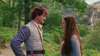 Movie still from “Ella Enchanted” (2004), directed by Tommy O'Haver – A man and a woman standing next to each other in front of a tree; Medium shot, Low angle