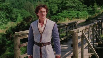 Movie still from “Ella Enchanted” (2004), directed by Tommy O'Haver – A man standing on top of a wooden bridge; Medium shot, Over the shoulder angle