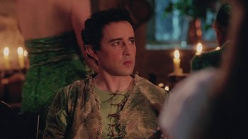 Movie still from “Ella Enchanted” (2004), directed by Tommy O'Haver – A man in a green shirt is looking to his left; Medium shot, Over the shoulder angle