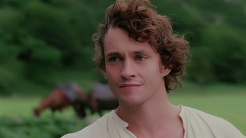 A person with curly brown hair