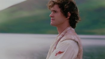 Movie still from “Ella Enchanted” (2004), directed by Tommy O'Haver – A young man with long brown hair wearing a white shirt; Close Up shot, Over the shoulder angle