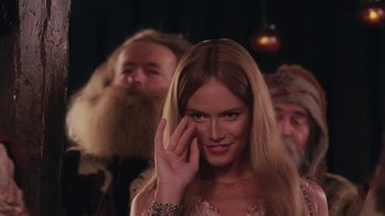 Movie still from “Ella Enchanted” (2004), directed by Tommy O'Haver – A beautiful woman with long blonde hair holding her hand up to her eye; Close Up shot, Over the shoulder angle