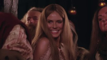 Movie still from “Ella Enchanted” (2004), directed by Tommy O'Haver – A woman with long blonde hair smiling for the camera; Close Up shot, Over the shoulder angle