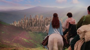 Movie still from “Ella Enchanted” (2004), directed by Tommy O'Haver – Two people on horseback looking out over a city skyline; Wide shot, High angle