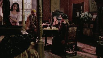 Movie still from “Ella Enchanted” (2004), directed by Tommy O'Haver – A group of people sitting at a table in a room; Wide shot, Over the shoulder angle