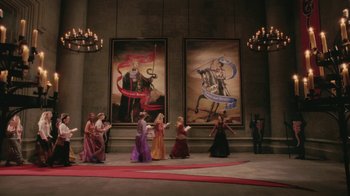 Movie still from “Ella Enchanted” (2004), directed by Tommy O'Haver – A group of people standing in front of two large paintings; Extreme Wide shot, High angle