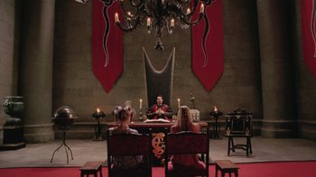 Movie still from “Ella Enchanted” (2004), directed by Tommy O'Haver – A group of people sitting at a table in a room; Wide shot, High angle