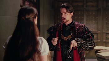 Movie still from “Ella Enchanted” (2004), directed by Tommy O'Haver – A man in a red and black outfit talking to a woman; Medium shot, Over the shoulder angle