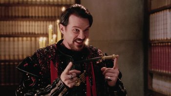 Movie still from “Ella Enchanted” (2004), directed by Tommy O'Haver – A man holding a sword in his hands; Medium shot, Over the shoulder angle