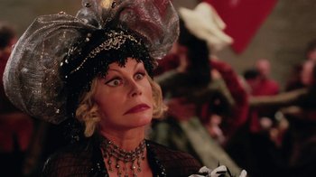 Movie still from “Ella Enchanted” (2004), directed by Tommy O'Haver – An older woman wearing a black hat and a necklace; Close Up shot, Over the shoulder angle