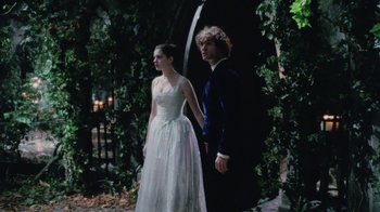 Movie still from “Ella Enchanted” (2004), directed by Tommy O'Haver – A man and a woman holding hands while standing in front of a waterfall; Wide shot, Low angle