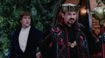 Movie still from “Ella Enchanted” (2004), directed by Tommy O'Haver – A man wearing a crown standing next to another man; Medium shot, Over the shoulder angle