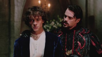 Movie still from “Ella Enchanted” (2004), directed by Tommy O'Haver – Two men standing next to each other in front of a wall; Medium shot, Over the shoulder angle