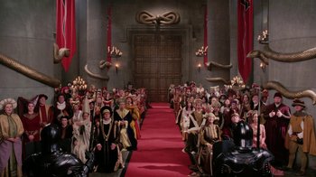 Movie still from “Ella Enchanted” (2004), directed by Tommy O'Haver – A group of people dressed up in costumes in front of a red carpet; Extreme Wide shot, High angle