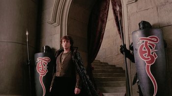 Movie still from “Ella Enchanted” (2004), directed by Tommy O'Haver – A man standing in front of a staircase in a castle; Medium shot, Over the shoulder angle