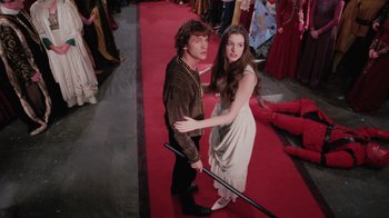 Movie still from “Ella Enchanted” (2004), directed by Tommy O'Haver – A man and a woman standing on a red carpet; Wide shot, High angle