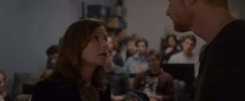 Movie still from “Elle” (2016), directed by Paul Verhoeven – A group of people sitting in a room; Close Up shot, Over the shoulder angle