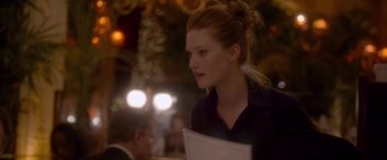 Movie still from “Elle” (2016), directed by Paul Verhoeven – A young woman is holding papers in her hands; Close Up shot, Over the shoulder angle