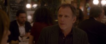 Movie still from “Elle” (2016), directed by Paul Verhoeven – A person wearing a suit; Close Up shot, Over the shoulder angle