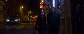 Movie still from “Elle” (2016), directed by Paul Verhoeven – A man and a woman walking down a street at night; Medium shot, Low angle