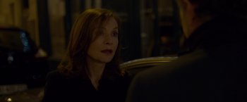 Movie still from “Elle” (2016), directed by Paul Verhoeven – A woman sitting in a car looking off into the distance; Close Up shot, Over the shoulder angle