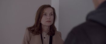 Movie still from “Elle” (2016), directed by Paul Verhoeven – A person looking at a mirror; Close Up shot, Over the shoulder angle