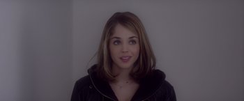 Movie still from “Elle” (2016), directed by Paul Verhoeven – A beautiful young lady wearing a black jacket; Close Up shot, Over the shoulder angle