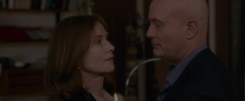 Movie still from “Elle” (2016), directed by Paul Verhoeven – A man and a woman looking at each other; Close Up shot, Over the shoulder angle