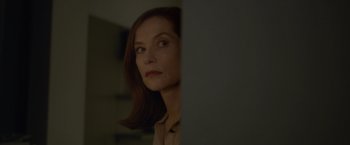 Movie still from “Elle” (2016), directed by Paul Verhoeven – A person looking at something in the dark; Close Up shot, Over the shoulder angle