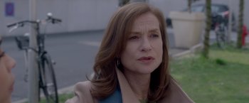 Movie still from “Elle” (2016), directed by Paul Verhoeven – A person with long brown hair; Close Up shot, Over the shoulder angle