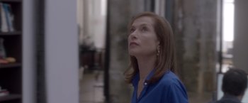 Movie still from “Elle” (2016), directed by Paul Verhoeven – A person wearing a blue shirt; Close Up shot, Low angle