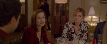 Movie still from “Elle” (2016), directed by Paul Verhoeven – Two women sitting at a dinner table in front of each other; Medium shot, Over the shoulder angle