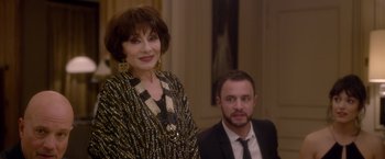 Movie still from “Elle” (2016), directed by Paul Verhoeven – An older woman standing next to a younger man; Close Up shot, Over the shoulder angle