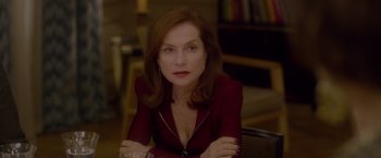 Movie still from “Elle” (2016), directed by Paul Verhoeven – A person sitting in a chair; Close Up shot, Over the shoulder angle