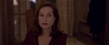 Movie still from “Elle” (2016), directed by Paul Verhoeven – A person with long hair; Close Up shot, Over the shoulder angle