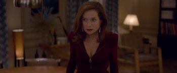 Movie still from “Elle” (2016), directed by Paul Verhoeven – A person wearing a red dress; Medium shot, Over the shoulder angle