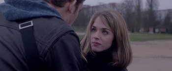 Movie still from “Elle” (2016), directed by Paul Verhoeven – A young man and a young woman looking at one another; Close Up shot, Over the shoulder angle