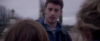 Movie still from “Elle” (2016), directed by Paul Verhoeven – A man standing next to a woman on a sidewalk; Close Up shot, Over the shoulder angle