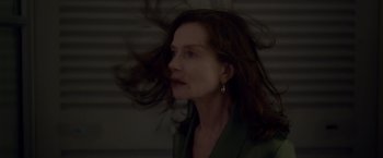 Movie still from “Elle” (2016), directed by Paul Verhoeven – A person with long brown hair; Close Up shot, Low angle