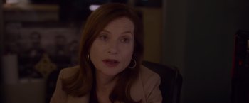 Movie still from “Elle” (2016), directed by Paul Verhoeven – A person sitting in a chair; Close Up shot, Over the shoulder angle