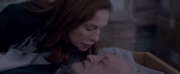 Movie still from “Elle” (2016), directed by Paul Verhoeven – A person with their head on a mans face; Close Up shot, High angle