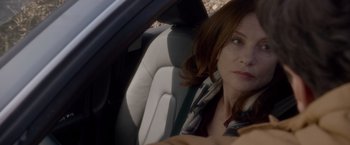 Movie still from “Elle” (2016), directed by Paul Verhoeven – A person sitting in a car; Close Up shot, Over the shoulder angle