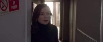 Movie still from “Elle” (2016), directed by Paul Verhoeven – A person wearing a black shirt; Close Up shot, Over the shoulder angle