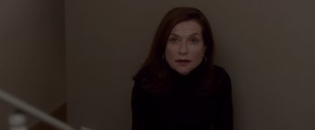 Movie still from “Elle” (2016), directed by Paul Verhoeven – A person wearing a black shirt; Close Up shot, Low angle