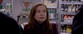 Movie still from “Elle” (2016), directed by Paul Verhoeven – A person wearing a jacket; Close Up shot, Over the shoulder angle