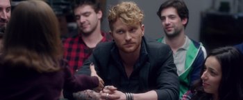 Movie still from “Elle” (2016), directed by Paul Verhoeven – A group of people sitting around a room; Close Up shot, Over the shoulder angle